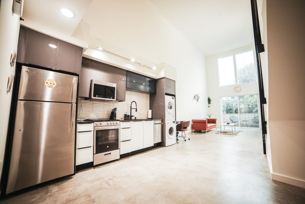 brown-wooden-kitchen-cabinet-near-white-wall-upmqnzgtlp0
